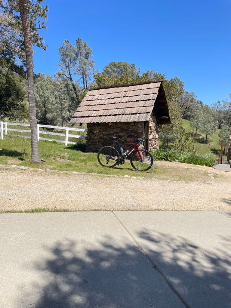 Road bike parked near a small ranch structure