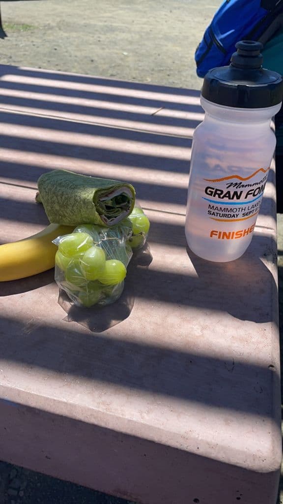 Tierra Bella rest stop with grapes, banana, wrap, and a Gran Fondo water bottle